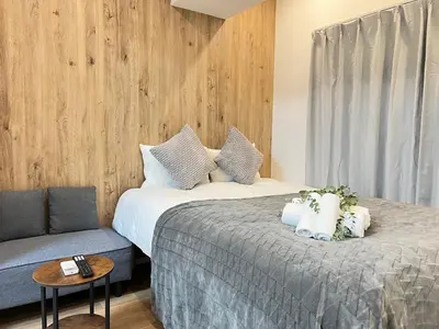 a hotel room with two beds and a couch at Ikebukuro Area 1F01 NishiikeApartment in Tokyo