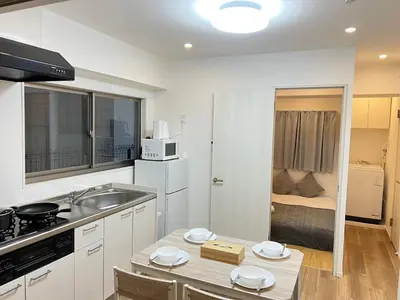 a kitchen with a sink and a table in a room at Ikebukuro Area 1F01 NishiikeApartment in Tokyo