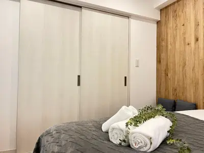 a bedroom with two towels on a bed at Ikebukuro Area 1F01 NishiikeApartment in Tokyo
