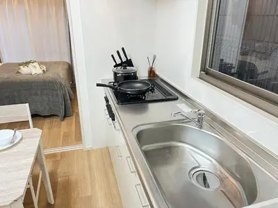a small kitchen with a sink and a stove at Ikebukuro Area 1F01 NishiikeApartment in Tokyo