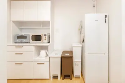 a kitchen with white cabinets and a white refrigerator at NEW OPEN! 3bedroom house in Ikebukuro with a carp \u3048\u3060\u307e\u3081\u30a4\u30f3 in Tokyo