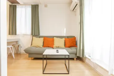 a living room with a couch and a table at NEW OPEN! 3bedroom house in Ikebukuro with a carp \u3048\u3060\u307e\u3081\u30a4\u30f3 in Tokyo
