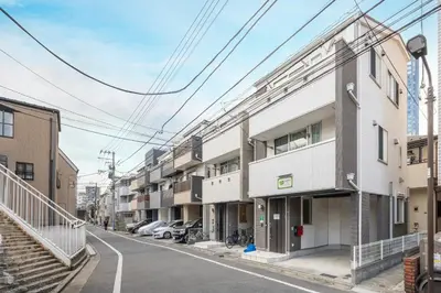 a row of buildings on a city street at NEW OPEN! 3bedroom house in Ikebukuro with a carp \u3048\u3060\u307e\u3081\u30a4\u30f3 in Tokyo
