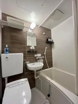 a bathroom with a toilet and a sink and a tub at daren stay in Tokyo
