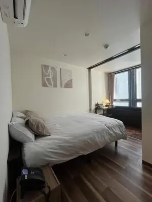 a bedroom with a large bed with a large window at daren stay in Tokyo