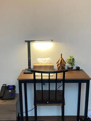 a desk with a lamp and a telephone on it at daren stay in Tokyo