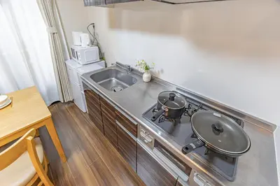 a kitchen with a stove and a sink at Waseda 2Bedroom Apt 1 Min to Station, Direct to Ikebukuro, Near Shinjuku in Tokyo