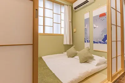 a bedroom with a bed in a room with a window at Waseda 2Bedroom Apt 1 Min to Station, Direct to Ikebukuro, Near Shinjuku in Tokyo