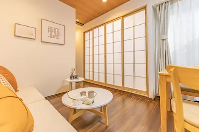 a living room with a couch and a table at Waseda 2Bedroom Apt 1 Min to Station, Direct to Ikebukuro, Near Shinjuku in Tokyo