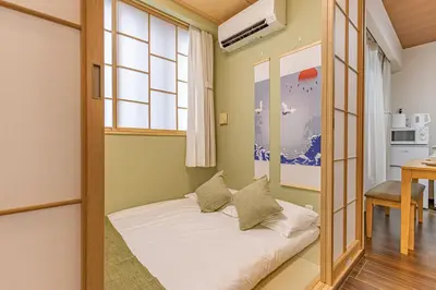 a bedroom with a bed in a room with a window at Waseda 2Bedroom Apt 1 Min to Station, Direct to Ikebukuro, Near Shinjuku in Tokyo