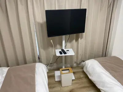 a room with two beds and a flat screen tv at ichigo ichie 8minute walk HigashiMukojima Tokyo sightseeing in Tokyo