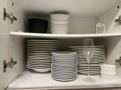 a stack of plates and a wine glass in a cabinet at ichigo ichie 8minute walk HigashiMukojima Tokyo sightseeing in Tokyo