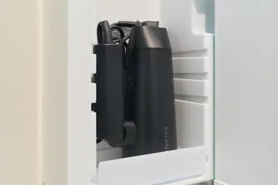 a shelf in a refrigerator filled with black items at AQUA RESIDENCE Sangenjaya by Tranova in Tokyo
