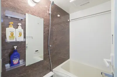a bathroom with a shower and a glass shower backdoor at AQUA RESIDENCE Sangenjaya by Tranova in Tokyo