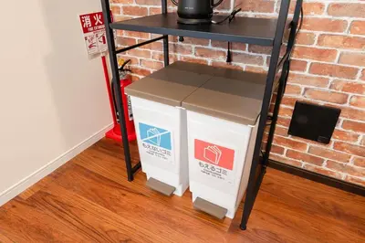 two boxes under a table next to a brick wall at tai\u5357\u5143\u753a25 in Tokyo
