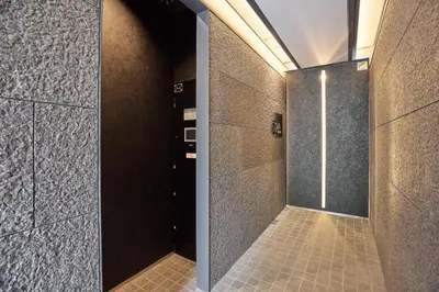 a bathroom with a walk in shower with a door at Azabu artemis in Tokyo