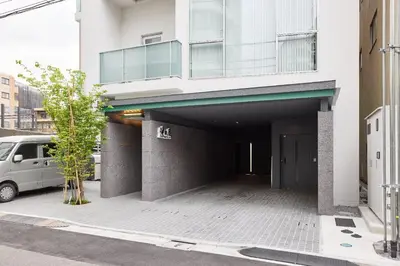a parking garage with a van in front of a building at Azabu artemis in Tokyo