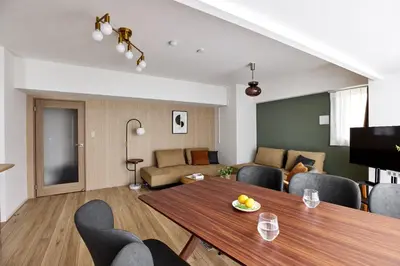 a living room with a table and chairs and a couch at Azabu artemis in Tokyo
