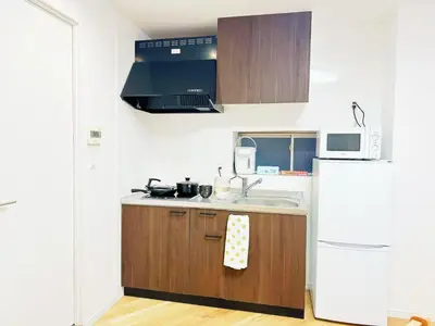 a small kitchen with a sink and a refrigerator at \u6587\u4eachouse 201\u5ba4 in Tokyo