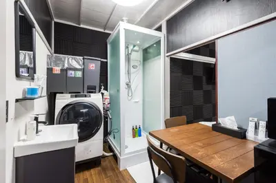a laundry room with a washing machine and a table at AkebonoHouse103 in Tokyo