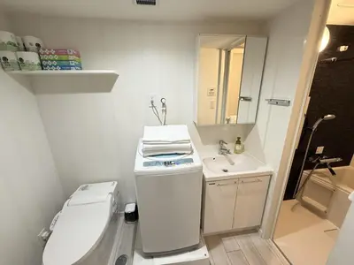 a small bathroom with a toilet and a sink at NDZ103 3 min walk to station, 2 lines, Yamanote Line, high-speed Wi-Fi in Tokyo
