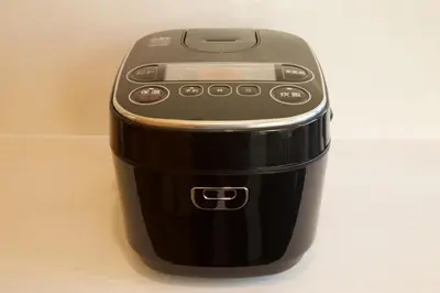 a cell phone sitting on top of a coffee maker at TOMALCO INN NAKANO 1 4F Flat 2 Bath 13min to Shinjuku from Honancho in Tokyo