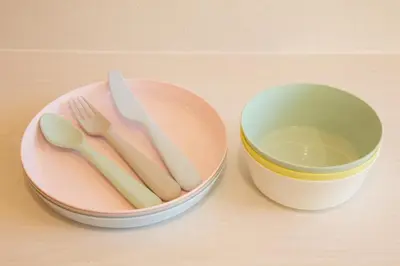 a plate with a fork and knife next to a cup at TOMALCO INN NAKANO 1 4F Flat 2 Bath 13min to Shinjuku from Honancho in Tokyo