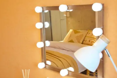 a room with a mirror and a lamp and a bed at TOMALCO INN NAKANO 1 4F Flat 2 Bath 13min to Shinjuku from Honancho in Tokyo