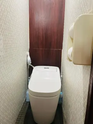 a small bathroom with a toilet in a stall at Lucky Hostel in Tokyo