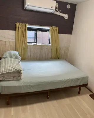 a bed in a room with a window at Lucky Hostel in Tokyo