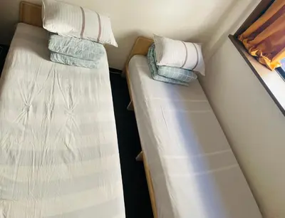 two bunk beds in a small room at Lucky Hostel in Tokyo