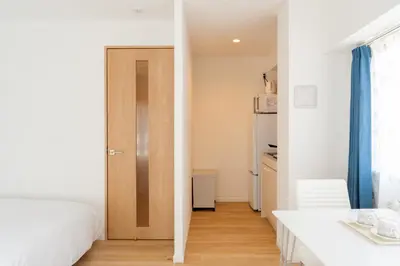 a small bedroom with a bed and a kitchen at Humming Kinshicho 303-202-301 - Vacation STAY 19264 in Tokyo