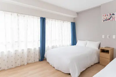 a bedroom with a white bed and a large window at Humming Kinshicho 303-202-301 - Vacation STAY 19264 in Tokyo