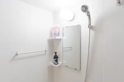 a bathroom with a mirror and a bottle on the wall at Humming Kinshicho 303-202-301 - Vacation STAY 19264 in Tokyo