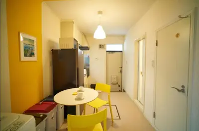 a small kitchen with a table and yellow chairs at Heights Omiya - Vacation STAY 15175 in Tokyo