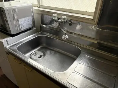 a stainless steel sink in a kitchen with a microwave at Heights Omiya - Vacation STAY 19467 in Tokyo