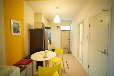a small kitchen with a table and yellow chairs at Heights Omiya - Vacation STAY 19467 in Tokyo