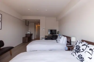 a hotel room with two beds and a television at LANG HOTEL Kameido - Vacation STAY 79534v in Tokyo