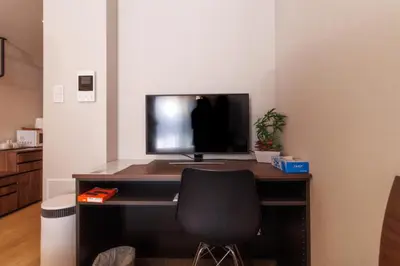 a desk with a monitor and a chair in a room at LANG HOTEL Kameido - Vacation STAY 79534v in Tokyo