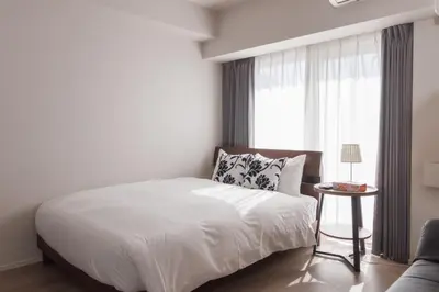 a white bedroom with a bed and a window at LANG HOTEL Kameido - Vacation STAY 76855v in Tokyo