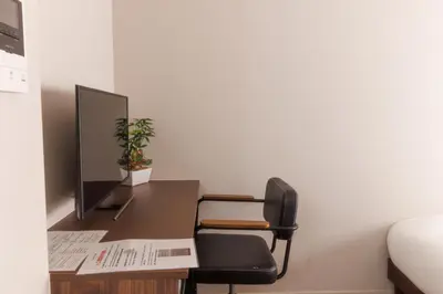 a desk with a computer monitor and a chair at LANG HOTEL Kameido - Vacation STAY 76855v in Tokyo