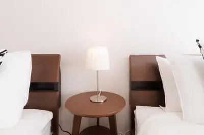 a lamp sitting on a table next to two beds at LANG HOTEL Kameido - Vacation STAY 79478v in Tokyo