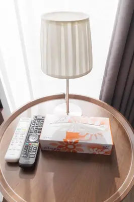 a table with a remote control and a lamp on it at LANG HOTEL Kameido - Vacation STAY 79246v in Tokyo