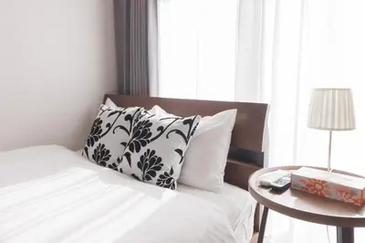 a bed with black and white pillows and a table at LANG HOTEL Kameido - Vacation STAY 79246v in Tokyo