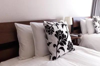 a bed with a black and white pillow on it at LANG HOTEL Kameido - Vacation STAY 79388v in Tokyo