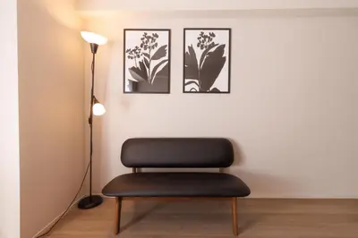 a chair in a room with three pictures on the wall at LANG HOTEL Kameido - Vacation STAY 79388v in Tokyo