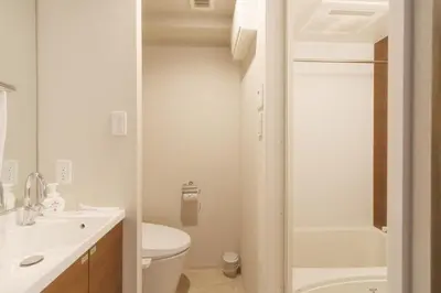 a white bathroom with a toilet and a sink at LANG HOTEL Kameido - Vacation STAY 79388v in Tokyo