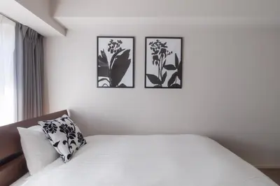 a white bedroom with three pictures on the wall at LANG HOTEL Kameido - Vacation STAY 79517v in Tokyo