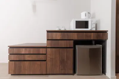 a microwave sitting on top of a wooden cabinet at LANG HOTEL Kameido - Vacation STAY 79517v in Tokyo