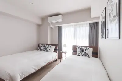 a bedroom with two beds and a window at LANG HOTEL Kameido - Vacation STAY 79460v in Tokyo